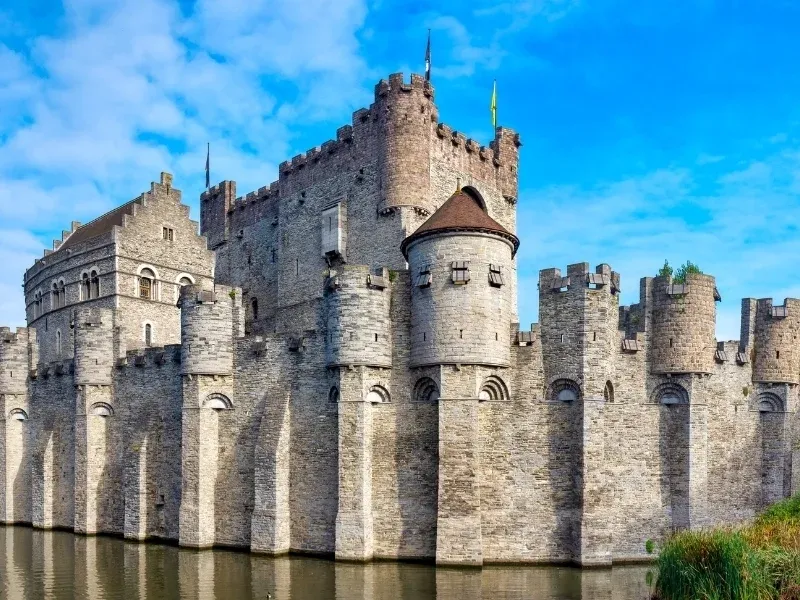 The stone towers of Gravensteen castle rising above the rooftops of Ghent.